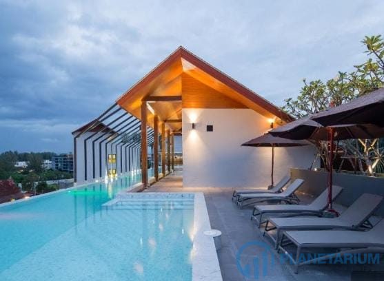 A pool with lounge chairs and umbrellas